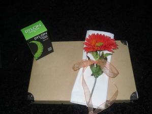 A napkin I made out of a soft bedsheet with one of my flowers and tied with ribbon. I am going to dye the mapkins in the green dylon dye :)