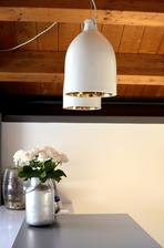 The clever Buffer Lamp by designer Wieki Somers looks noncommittal at first glance. But inside its delicate porcelain shell a gold or silver colored finish gives the emerging light a warm rich glow that makes even the chilliest room inviting and cosy