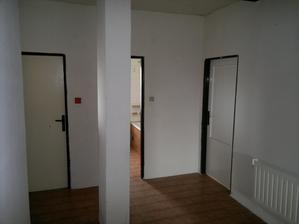 Úplně vlevo (není vidět) vstup do ložnice, vlevo wc, za sloupkem koupelna a vpravo budoucí dětský pokoj, koupelna přijde rozšířit až ke sloupku