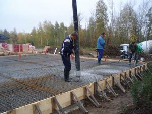 vzadu chlapi používají vibrátor na beton